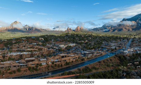 Aerial view of Sedona, Arizona with clouds covering some of the mountains.