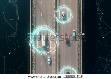 Aerial view of self driving autopilot cars driving on a highway with technology tracking them, showing speed and who is controlling the car. Visual effects clip shot.