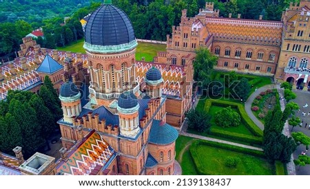 Aerial view of the Seminary Residence and the Church of the Three Saints. UNESCO. architecture. Old historical university building with towers, domes and green garden Chernivtsi, Ukraine 