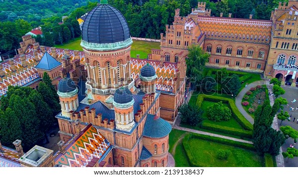 Aerial view of the Seminary Residence and the Church of\
the Three Saints. UNESCO. architecture. Old historical university\
building with towers, domes and green garden Chernivtsi, Ukraine\
