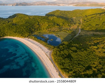 Aerial view of a serene beach with turquoise water and a tranquil lagoon. - Powered by Shutterstock