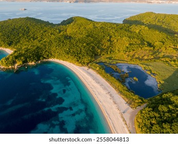 Aerial view of a serene beach with turquoise water and a tranquil lagoon. - Powered by Shutterstock