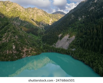 Aerial view of a serene mountain lake surrounded by lush forests and rugged mountains at dusk, reflecting the sky's pastel hues in its tranquil waters. Ideal for nature and travel themes - Powered by Shutterstock