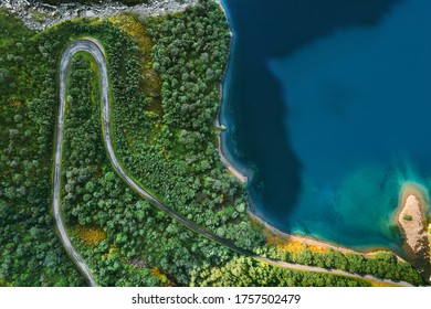 Aerial View Serpentine Road And Forest With Sea Drone Landscape In Norway Above Trees And Blue Sea Water Scandinavian Nature Wilderness Top Down Scenery 