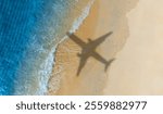 Aerial view of shadow passenger plane silhouette and sandy beach  blue sea with waves at sea beach summer vacation sea travel concept