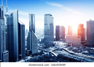 Aerial view of Shanghai's high density central business area. High rise office buildings and skyscrapers with glass surface. Urban roads with multiple lanes and green city park. Shanghai, China - Powered by Shutterstock