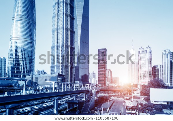 Aerial view of Shanghai\'s high density central\
business area. High rise office buildings and skyscrapers with\
glass surface. Urban roads with multiple lanes and green city park.\
Shanghai, China