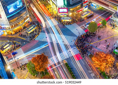 Aerial view of Shibuya Crossing, Tokyo. The scramble crosswalk is one of the largest in the world. Long exposition with light trail - Shutterstock ID 519032449