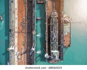 Aerial View Shipyard Have Crane Machine And Container Ship In Green Sea 