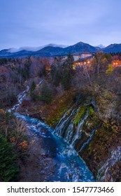 Aerial view of Shirahige Waterfall in twillight autumn, Kamikawa District, Hokkaido, Japan.With long exposure technique created movement tree leaf and smooth river surface.  - Shutterstock ID 1547773466