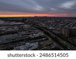 An aerial view of Shore Parkway and the industrial area on the shores of Gravesend Bay during a colorful and cloudy sunset, Brooklyn, New York
