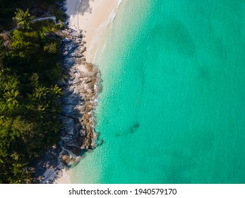 Aerial View Shot. Drone Camera Over White Beach Sand And Sew Water Clear. Nature Video View Of Beautiful Tropical Beach And Sea In Sunny Day. Palm Tree At Beach. At Phuket, Thailand.