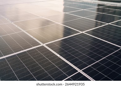 Aerial view showing a solar panels array on factory - warehouse rooftop close up. Solar cell array installed on the building rooftop, renewable and sustainable energy concept.
