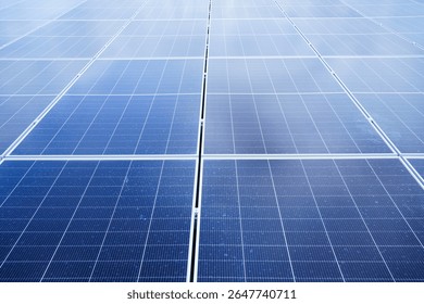 Aerial view showing a solar panels array on factory - warehouse rooftop close up. Solar cell array installed on the building rooftop, renewable and sustainable energy concept.