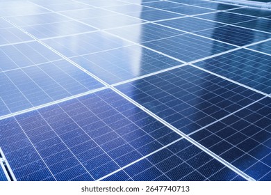 Aerial view showing a solar panels array on factory - warehouse rooftop close up. Solar cell array installed on the building rooftop, renewable and sustainable energy concept.