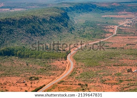 Aerial view of a shrub-covered ridge of the Great Rift Valley, paralleled by a main road leading north towards Nairobi, Kenya