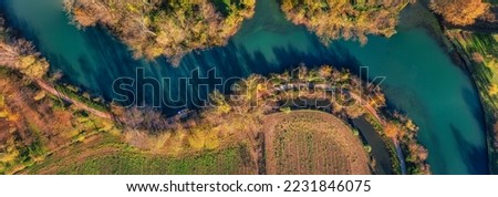 Aerial view of the Sile river at S. Elena di Silea (Treviso, Italy) at sunrise in autumn