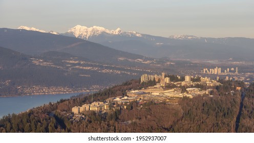 Aerial view of Simon Fraser University, SFU, on Burnaby Mountain. Picture taken from an Airplane in Vancouver Lower Mainland, British Columbia, Canada. Sunny Sunset
