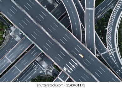 Aerial View Of Single Car Driving On Highway And Overpass In City