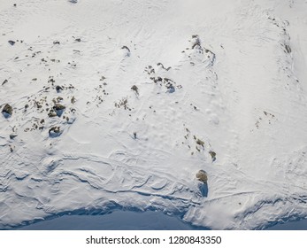 Aerial view of ski tracks in alpine region along cornice on ridge in mountains. Backcountry skiing - Powered by Shutterstock