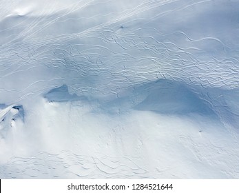 Aerial View Of Ski Tracks In Snow. Backcountry Skiing In Powder, Leaving Trails In Snow.