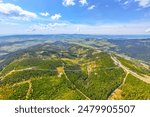 Aerial view of the Sky Bridge 721, the worlds longest suspension footbridge, stretching across a forested mountain in Czechia. The unique Sky Walk lookout tower stands nearby, offering panoramic views