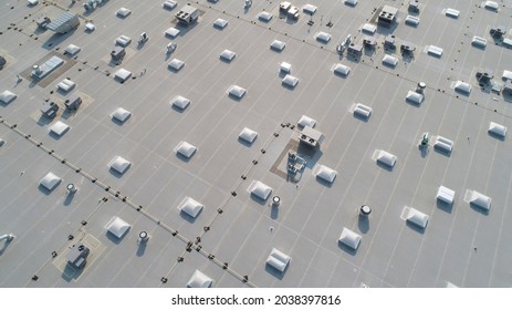 Aerial view of skylights and HVAC equipment on top of a commercial roof building