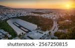 Aerial view of the skyline of Athens, Greece, with the historic Panathenaic Stadium during sunset time