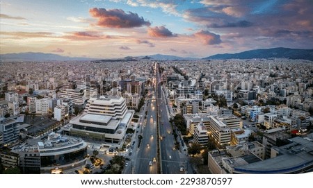 Aerial view of the skyline of Athens, Greece, during sunset time with Syggrou Avenue leading from the south suburbs in to the city center
