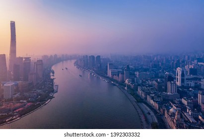 Aerial View Of Skyscraper And High-rise Office Buildings In Shanghai Downtown With Fog, China. Financial District And Business Centers In Smart City In Asia At Sunrise.