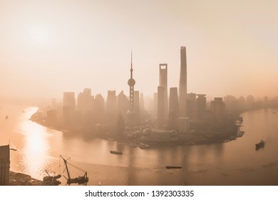 Aerial View Of Skyscraper And High-rise Office Buildings In Shanghai Downtown With Fog, China. Financial District And Business Centers In Smart City In Asia At Sunrise.