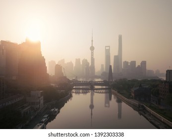 Aerial View Of Skyscraper And High-rise Office Buildings In Shanghai Downtown With Fog, China. Financial District And Business Centers In Smart City In Asia At Sunrise.