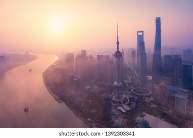 Aerial View Of Skyscraper And High-rise Office Buildings In Shanghai Downtown With Fog, China. Financial District And Business Centers In Smart City In Asia At Sunrise.