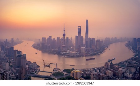 Aerial View Of Skyscraper And High-rise Office Buildings In Shanghai Downtown With Fog, China. Financial District And Business Centers In Smart City In Asia At Sunrise.