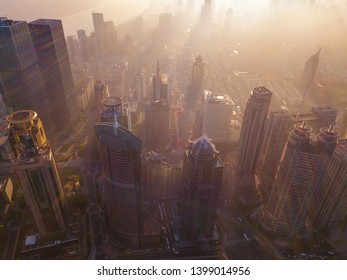 Aerial View Of Skyscraper And High-rise Office Buildings In Shanghai Downtown With Fog Or Mist, China. Financial District And Business Centers In Smart City In Asia At Sunrise.