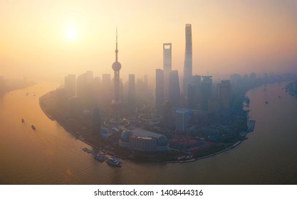 Aerial View Of Skyscraper And High-rise Office Buildings In Shanghai Downtown With Fog Or Mist, China. Financial District And Business Centers In Smart City In Asia At Sunrise.