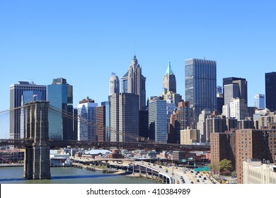 Aerial view of Skyscrapers in Financial District of Lower Manhattan through Brooklyn Bridge, New York City, USA.