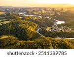 Aerial view of Slapy Water Reservoir at sunset, surrounded by lush hills and greenery, highlighting the tranquility of this key part of the Vltava Cascade.