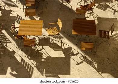 Aerial view of slatted table and chairs with shadows. - Powered by Shutterstock