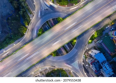 aerial view of small circular urban overpass, road interchange at night 