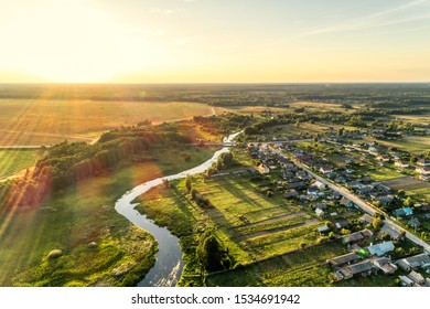 Aerial View. Small European Village. Blue Winding River. Summer Evening, Sunny Sunset.