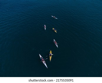 Aerial View Of A Small Group Of People Sea Kayaking