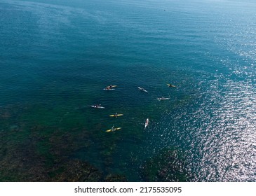 Aerial View Of A Small Group Of People Sea Kayaking