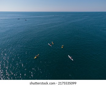 Aerial View Of A Small Group Of People Sea Kayaking