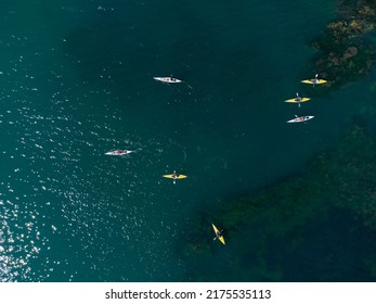 Aerial View Of A Small Group Of People Sea Kayaking