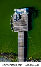 An Aerial View Of A Small And Rustic Boat Dock On A Lake Outside Of Pagosa Springs, Colorado. The Green Color In The Water Is From An Extreme Algae Bloom.