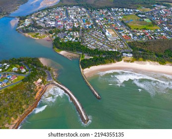 An Aerial View Of A Small Town On The Bank Of A River