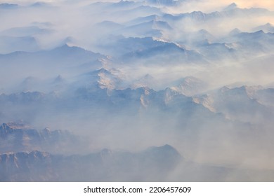 An Aerial View Of A Smoky Sky Where Mountain Ridges Are Present.