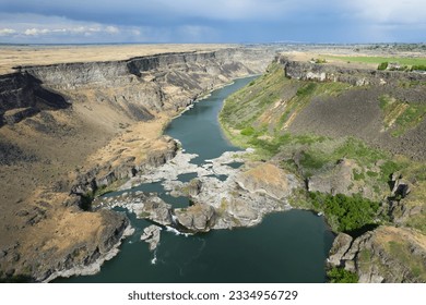 Aerial view of the Snake River canyon with the snake river and surrounding green grassland. Shot near the Perrine Memorial Bridge in Twin Falls, Idaho state, USA. - Powered by Shutterstock