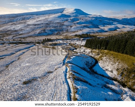 Aerial view of the snow covered path from Pont-ar-Daf to the summit of Corn Du and Pen-y-Fan in the Brecon Beacons